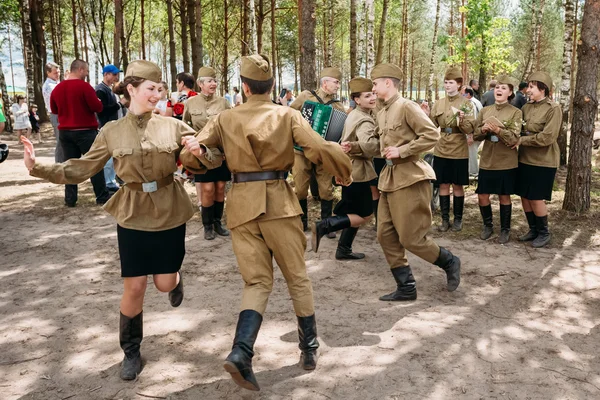 Artists dressed as Soviet Russian soldiers dance during events d