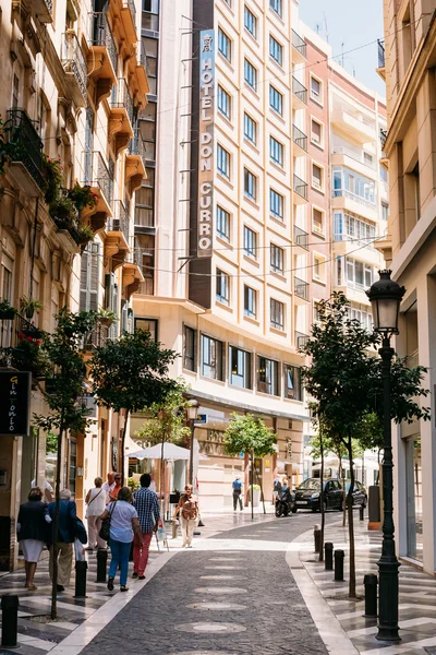 People walking along Sancha de Lara street in Malaga, Spain