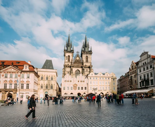 Tourists walking on old square on background of the Church Of Ou