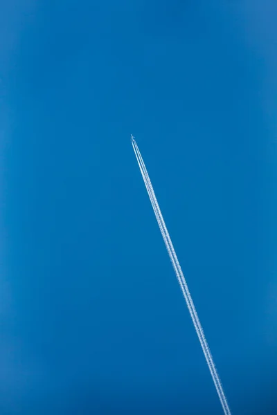 Airplane In Sky With Plane Trails