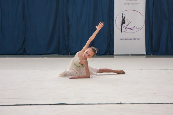 The competition of art gymnastics. Young gymnast during her performance