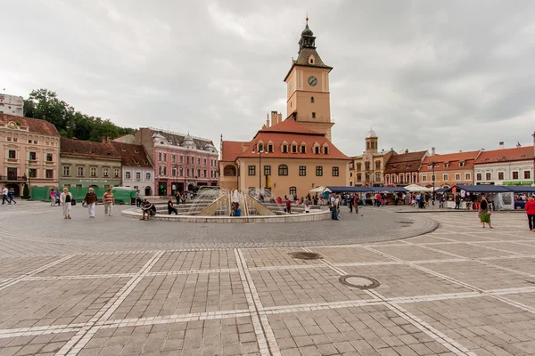 The renovated market square. Flock of Tourists walking on the main square of the city