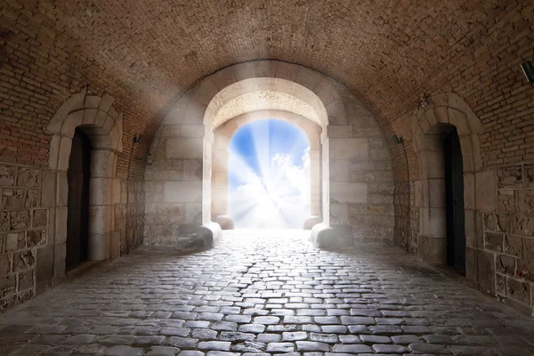 There is the light sky in the end of arch in a tunnel