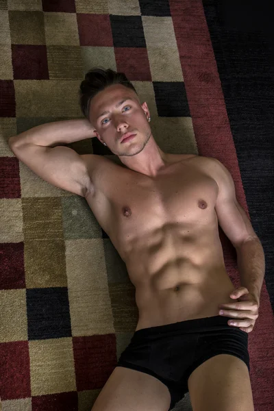 Cool handsome young man laying on the floor
