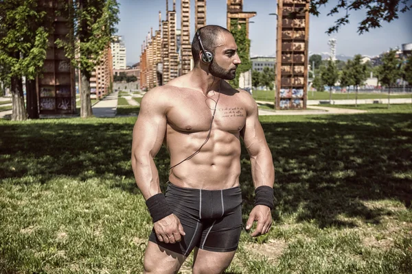 Handsome Muscular Shirtless Hunk Man Outdoor in City Setting