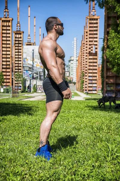Handsome Muscular Shirtless Hunk Man Outdoor in City Setting