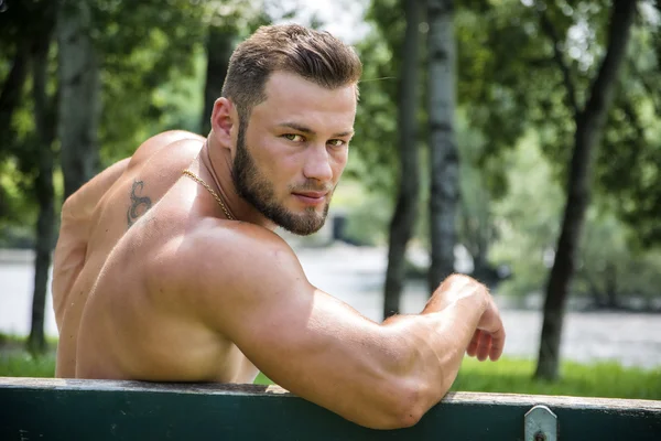 Handsome Muscular Shirtless Hunk Man Outdoor in City Park