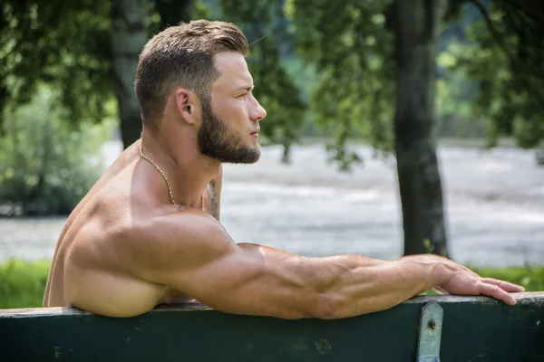Handsome Muscular Shirtless Hunk Man Outdoor in City Park
