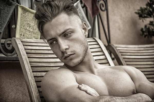 Young Man Sunbathing on Lounge Chair