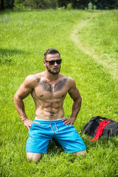 Handsome Muscular Shirtless Hunk Man Outdoor in City Park