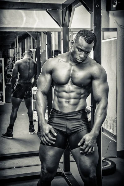 Handsome black male bodybuilder resting after workout