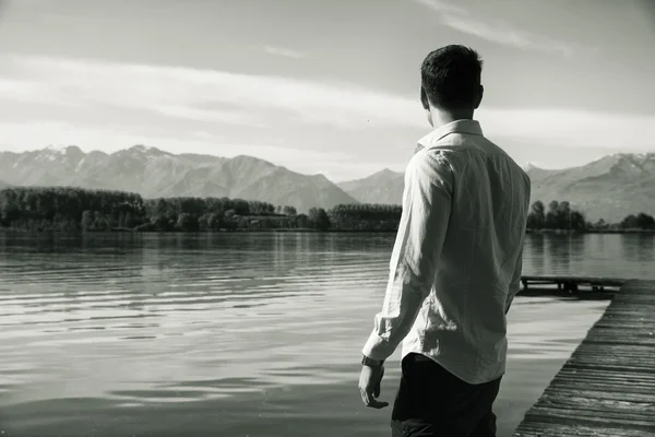 Attractive young man on a lake in a sunny