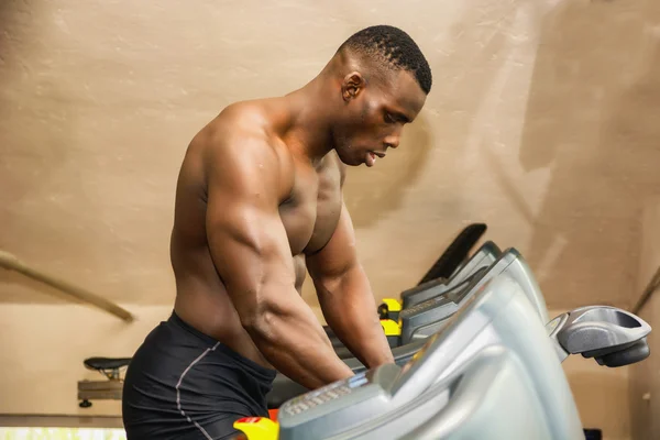 Muscular black male bodybuilder exercising
