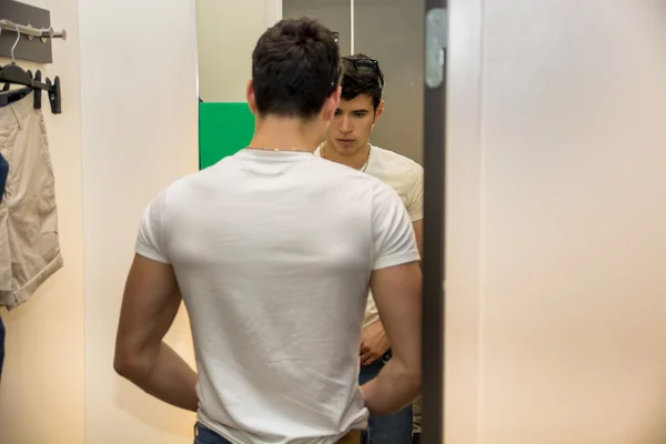 Young Man Trying on Clothes in Clothing Store