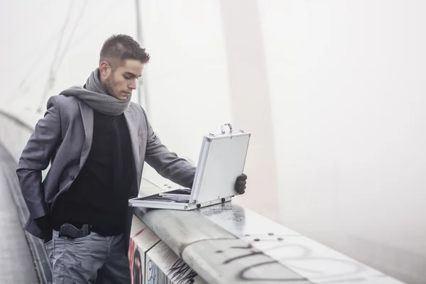 Stylish elegant businessman opening a briefcase