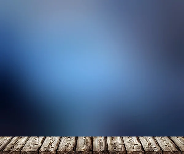 Old dark rustic wood texture. A broad wooden surface. Deep rich blue blur background. Fog texture. Rainy weather. Spring evening haze.