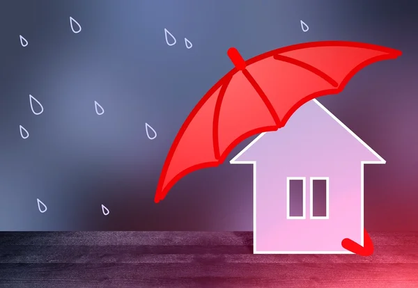 Red umbrella protects little home from the rain. Dark blue blur background. Smooth wooden surface texture.