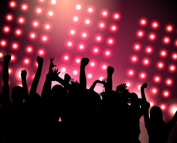 Silhouettes of crowds of people with their hands up at a festive party in the club. Dark pink background with lots of bright lights.