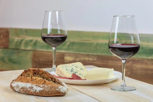 Bread, cheese and wine glasses