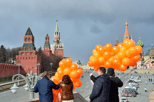 Moscow, Russia, March, 20, 2016, Russian scene: people with orange balloons in front of St. Basil\'s Cathedral in Moscow