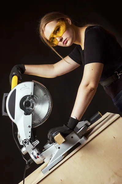 Woman with a circular disk saw
