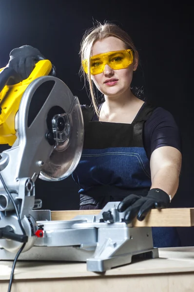 Woman with a circular disk saw