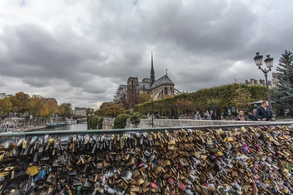 Locks on the Pont de l\'Archeveche bridge next to the Notre Dame de Paris cathedral in Paris, France