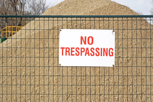 NO TRESPASSING sign at construction site