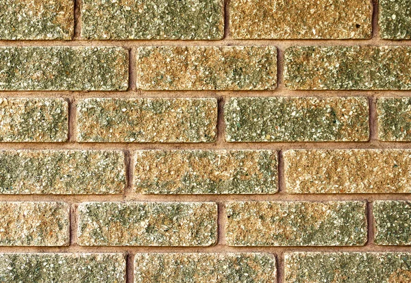 Close up of laid brick in two tone color of red and moss green