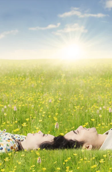 Couple lying down on the grass in springtime