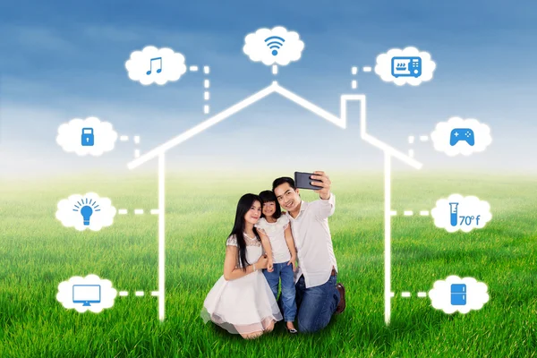 Family taking selfie under smart house