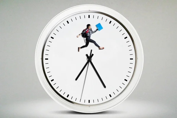 High school student jumping on the clock