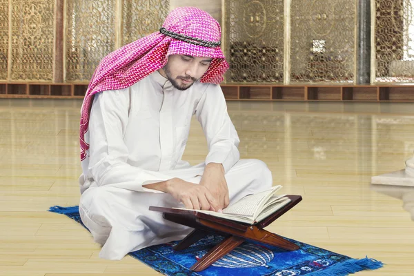Arabic person reading Quran in mosque