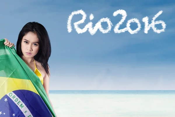 Woman with flag of Brazil and text of Rio 2016
