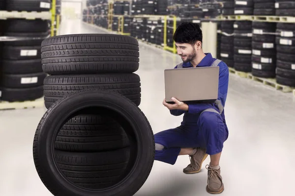 Mechanic checking the tires in store