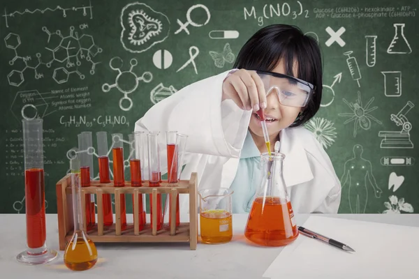 Cute female student doing chemical test