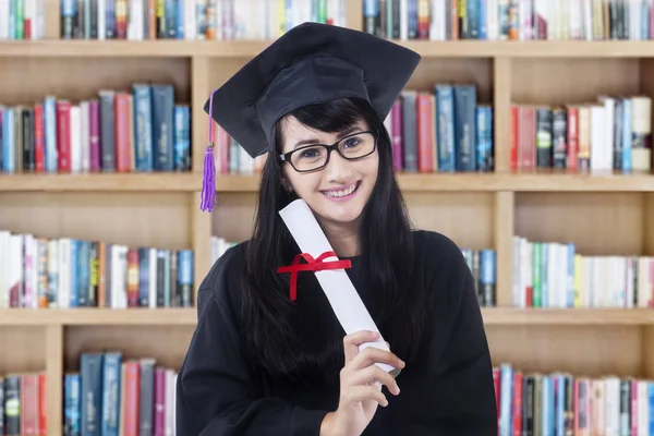 Young bachelor with certificate in library