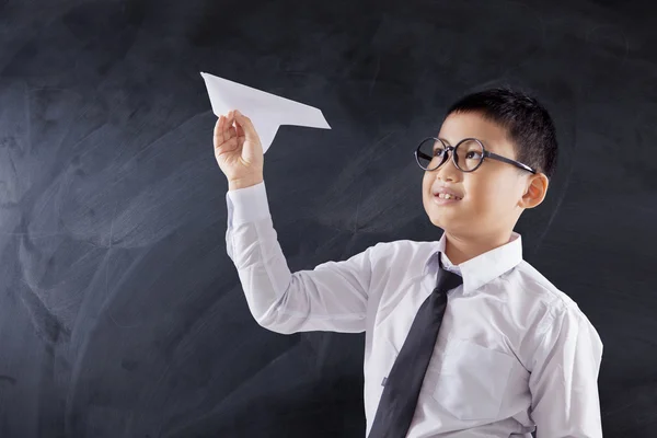 Boy playing paper airplane