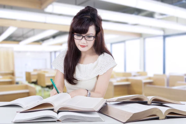 Clever student learns with books in class