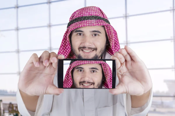 Arabian man smiling at the camera phone
