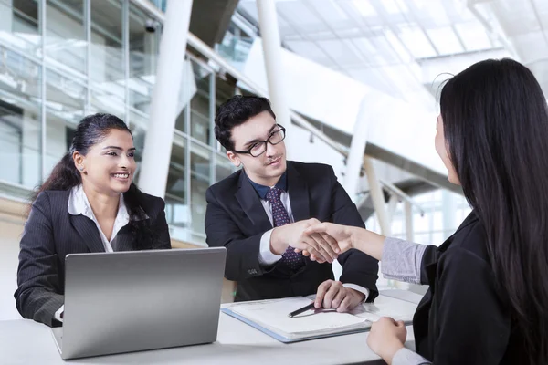 Businessman shaking hands with new worker