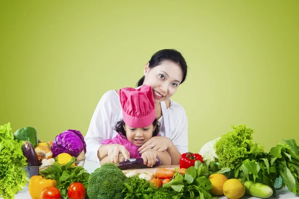 Mother and child cooking vegetables