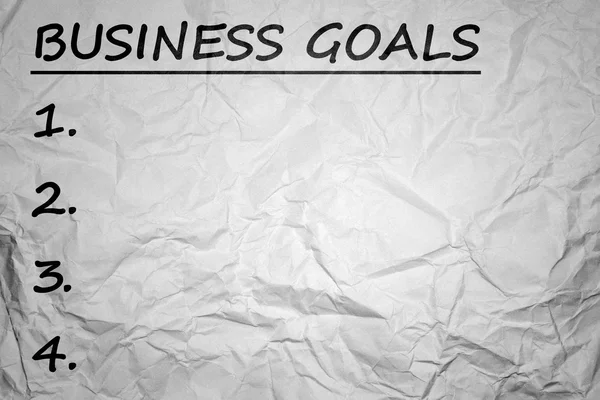 Business goals with crumpled paper background