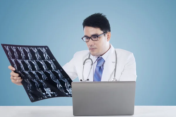 Doctor with laptop and roentgen image