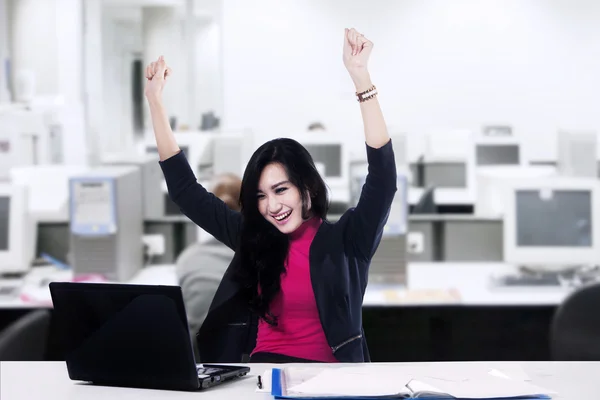 Successful businesswoman with arms up