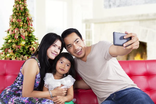 Family take a self photo together