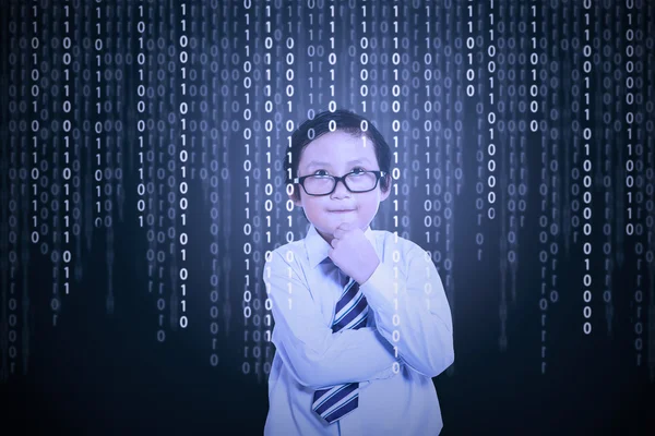 Little boy looking at binary code