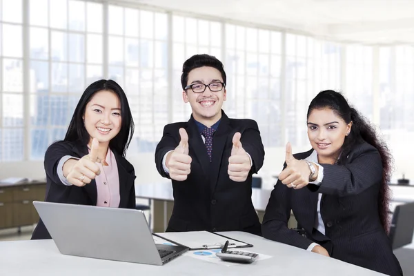 Businesspeople with thumbs up and smiling