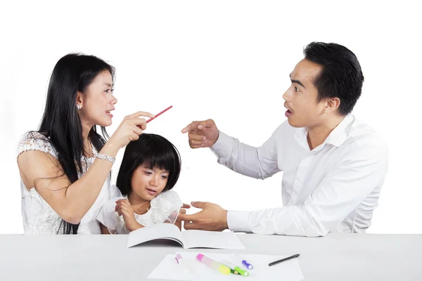 Two parents arguing near to their child