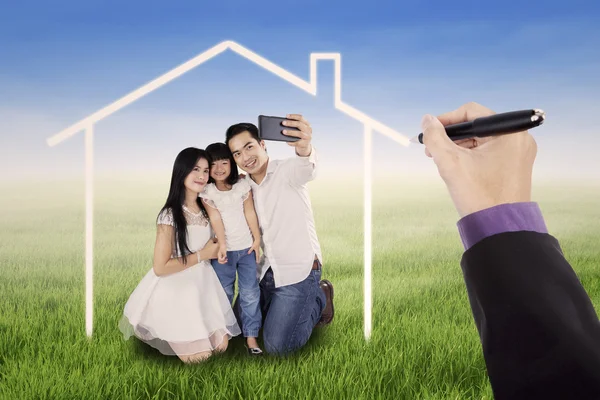 Family taking photo under a dream house